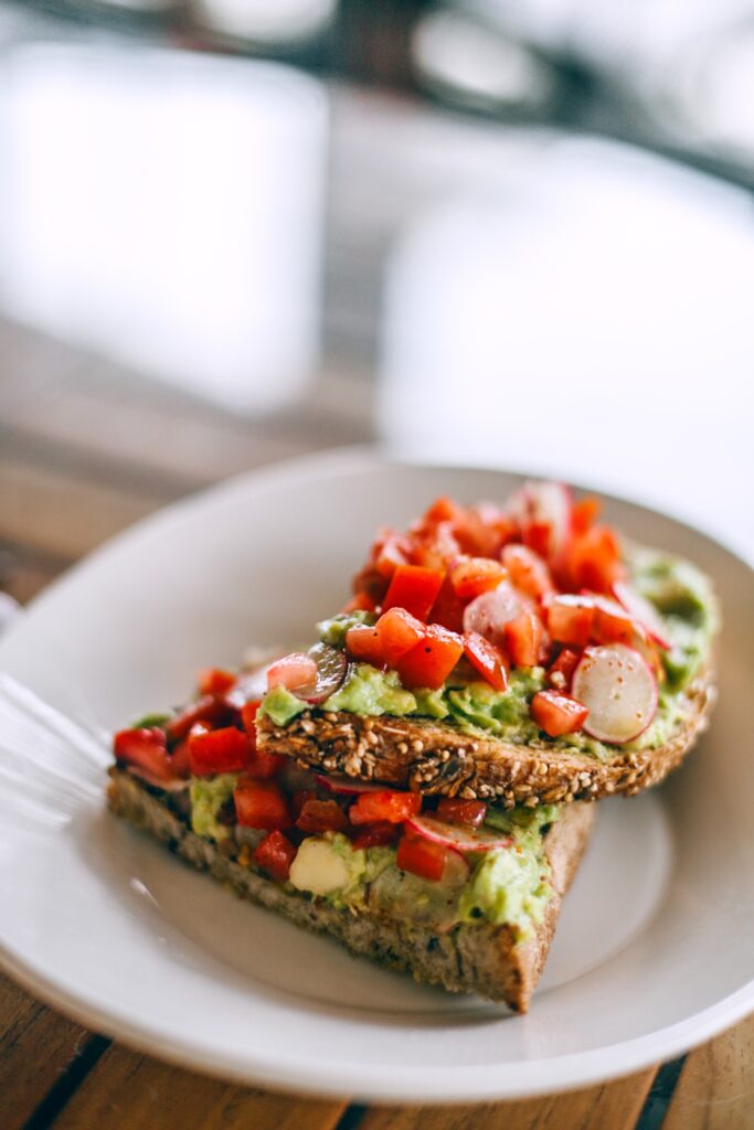 Healthy meals like this whole wheat bread with avocado, tomatoes and radishes can help with weight loss
